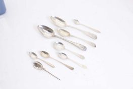 A collection of silver spoons,