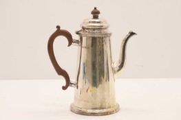 A silver coffee pot,