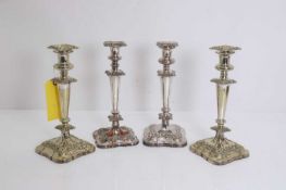 A harequin set of four silver plated candlesticks,