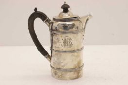 A silver hot water pot,