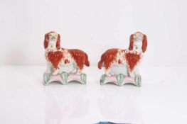 A pair of Staffordshire pottery spaniels,