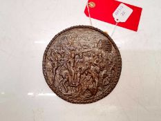 A bronze circular plaquette,