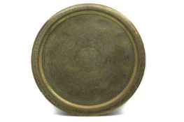 A Far Eastern brass circular charger,