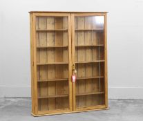 A slender pine two door display cabinet,