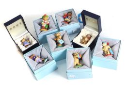 A collection of Halcyon Days enamel Teddy of the Year figures,