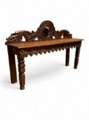 An Irish 19th century carved oak narrow hall bench