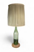 A large vintage glass glass bottle table lamp