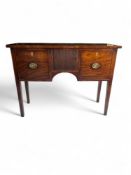 A small and narrow George III mahogany sideboard