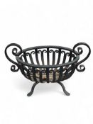 A vintage wrought iron twin-handled oval fire basket