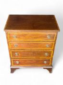 A small Edwardian mahogany and satinwood chest of drawers