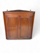 A late Victorian Aesthetic period walnut corner cupboard