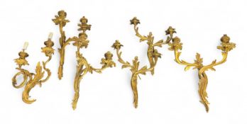 Two pairs of Louis XV style gilt bronze twin-light wall lights and two others