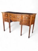 A 19th century mahogany serpentine sideboard in the George III style