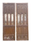 A pair of 19th century French carved oak and simulated oak plaster panelled doors