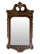 A late 19th / early 20th century George II style mahogany and parcel gilt mirror