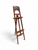 A late Victorian Aesthetic Movement carved mahogany standing easel