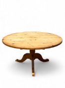 A vintage stripped pine scrub top circular kitchen table