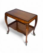 An early 20th century carved walnut trolley in the Georgian style