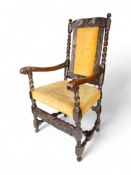 A 17th century carved oak open armchair
