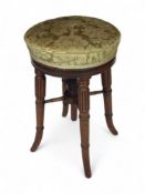 A Regency mahogany revolving piano stool