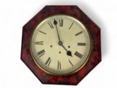 A red faux tortoiseshell octagonal wall clock