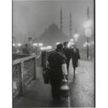 Ara Güler. 'Salep' Seller in early morning light on the old Galata Bridge. 1957