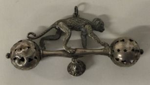 An unusual Victorian silver rattle cast with monkey.
