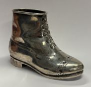A heavy silver model of a boot.