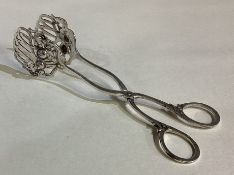 A pair of German silver muffin tongs.