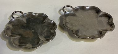 A pair of silver ashtrays.