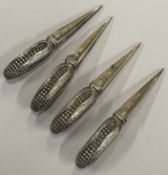 A set of four silver sweetcorn holders.