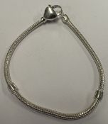 A child's silver heart charm bracelet.
