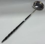 An early 19th Century Georgian silver toddy ladle.