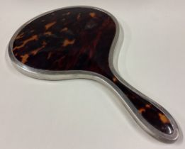CHESTER: A large silver and faux tortoiseshell mounted mirror.