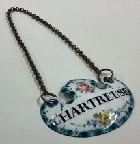 A rare enamelled decanter label for 'Chartreuse'.