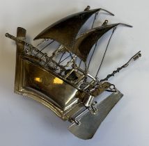 A large heavy silver model of a ship under sail.