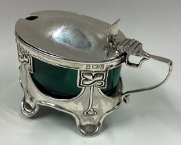 An Art Nouveau silver mustard pot.