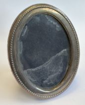 An oval silver-mounted picture frame.
