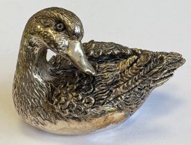 A heavy silver figure of a duck.