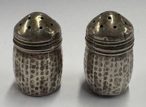 A pair of Sterling silver peppers.