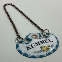 A rare enamelled decanter label for 'Kümmel'.