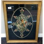 A gilt framed and glazed tapestry depicting birds and flowers.