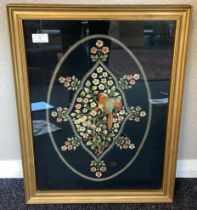 A gilt framed and glazed tapestry depicting birds and flowers.