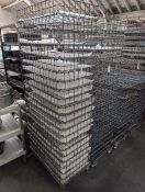 +VAT Stack of 46x77cm metal wire stacking trays on a metal 4 wheel dolly.