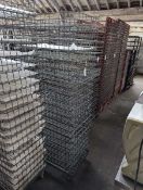 +VAT Stack of 46x77cm metal wire stacking trays on a metal 4 wheel dolly.