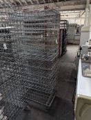 +VAT Stack of 46x77cm metal wire stacking trays on a metal 4 wheel dolly.