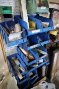 +VAT Rack of blue plastic linbins and contents together with a rack of miscellaneous linisher belts,