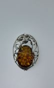 Silver pendant and broach set with natural amber