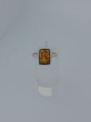Silver ring set with natural amber stone