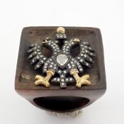 An Exquisite Eagle Ebony Ring Detailed With Brilliant Diamonds and Gold On Silver.